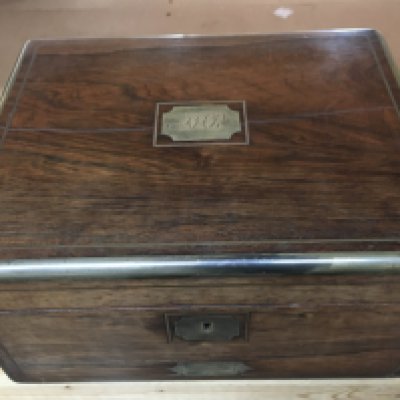 A George IV Rosewood and brass bound travelling toilet box with fitted interior including glass jars and boxes, lift out vanity mirror and drawer under