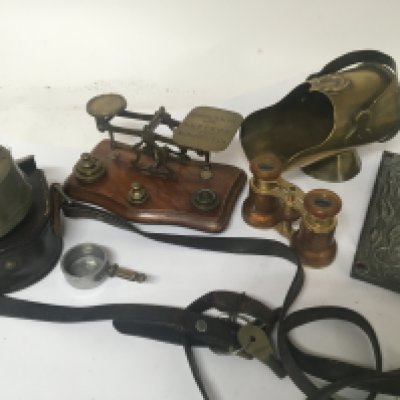 A collection of items comprising a set of brass beam balance postal scales with weights a British made Dent of London brass cased timing clock in a leather pouch a pair of decorative opra glasses a trench art scuttle and a pewter plaque. (a lot)