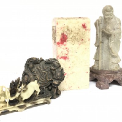 A collection of soapstone including a Sage figure (20.5cm tall), a seal (17.5cm tall), a soapstone deer and a carved wooden dragon. This lot cannot be posted