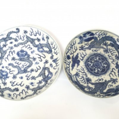 19/20th Century Chinese blue and white dragon plates, both with six character marks on the base. 26.5 and 24.5cm wide approximately. Damage and restoration seen. This lot cannot be posted