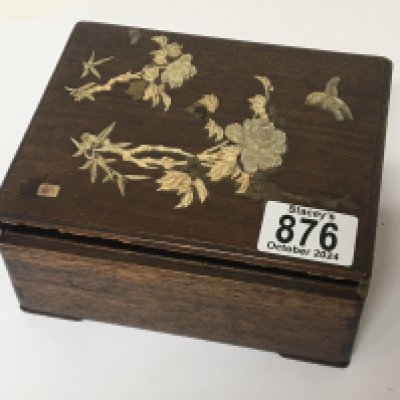 A late 19th century Japanese hardwood box decorated with raised and applied bone and mother of pearl with small signed tablet inset box edge loose but in box. 16x13cm