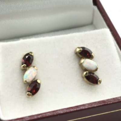 A pair of 9 carat opal and garnet stud earrings , 2.1g. Postage category a