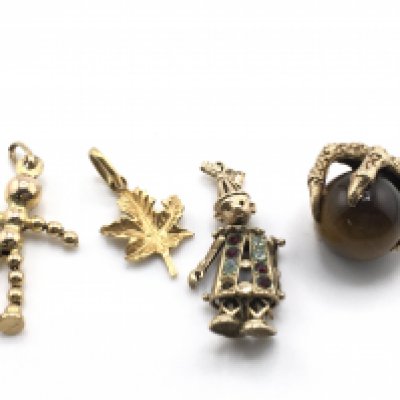 A collection of four gold charms, total weight 10.55g. Postage category A