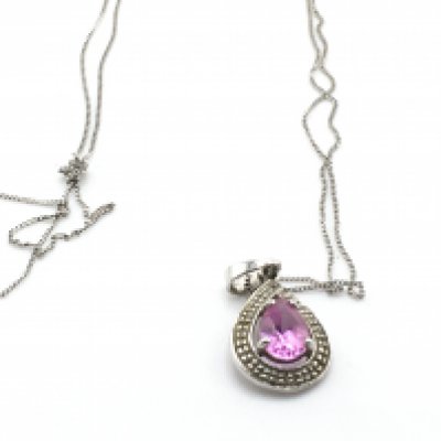A 9ct white gold chain and pendant set with pink stone. 1.5g Postage A