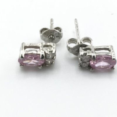 A pair of white metal earring set with pink sapphires. Postage A