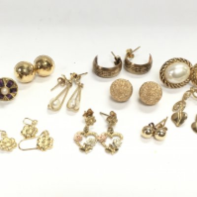 A collection of 9 carat gold earrings, 11g total weight. Postage category a