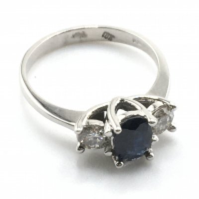 An 18ct white gold oval-cut sapphire and RBC diamond trilogy ring. Sapphire 0.85ct approx. Diamonds 0.40ct approx. Ring Size M/N. Ring weight 3.6g. Postage category a