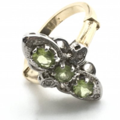 A 9ct white and yellow gold elongated vintage style ring set with 3 peridots and R/C diamonds. Peridots 0.30Ct. Diamonds 0.04Ct. Size N. Ring weight 6g. Postage category A