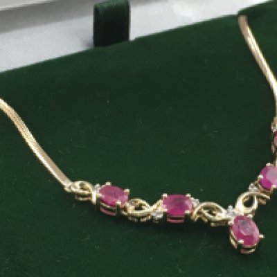 A 9ct yellow gold oval ruby and RBC diamond necklace, rubies 1.50ct approx. Diamonds 0.10ct approx. Weight 4.5g. Postage category a