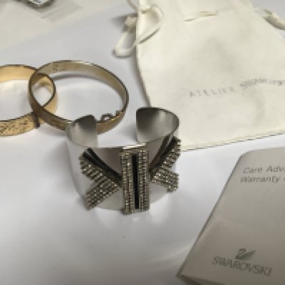 A 9carat gold bangle metal core a designer Swarovski crystal bracelet with pouch and paperwork and one other bangle (3)