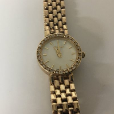 A 9carat gold ladies watch maker WHW with mother of pear effect dial and diamond set bezel 9carat gold strap weight 27g. Not seen working quartz will need a new battery.