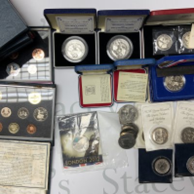 A collection of various coinage including Royal mint year sets, commemorative coinage, and some additional silver commemorative coinage. (Catagory B postage).