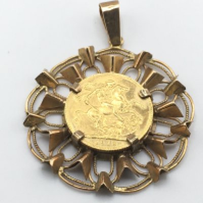 A 1918 full sovereign with I mint mark set in a gold mount (possible 14ct) 16.5g total. Postage A