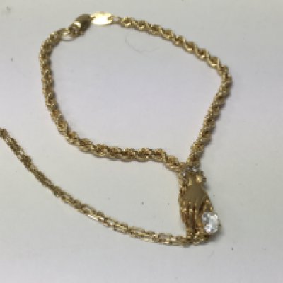 A 18 ct gold bracelet with hand design and diamond inset .