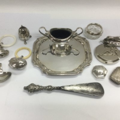 A collection of silver and silver plated items including a small tray, teething rings, vesta case etc. Shipping category B.