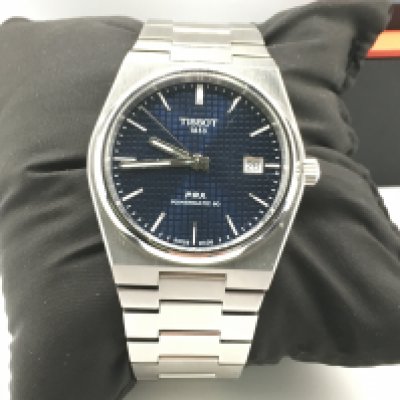 A tissot PRX powermatic 80 wrist watch with box and paperwork. Postage B