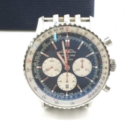 A boxed Breitling Navitimer chronograph wrist watch with papers. Exhibition case back. 46mm with blue dial. Seen running. Extra links included. Good condition would benefit from a clean.
