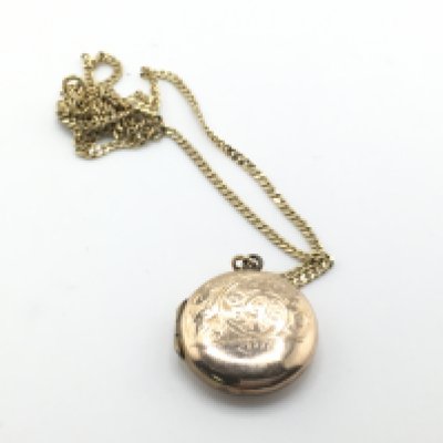 A 9ct gold chain with a gold front and back locket. 6.4g Postage A