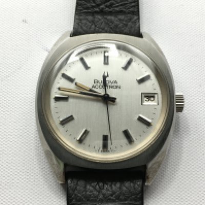 A Bulova accutron wrist watch with date aperture. Not seen working. Postage B