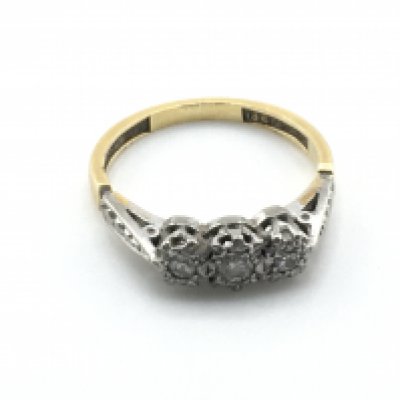 An 18ct gold ring set with three small diamonds. 2.3g and J Postage A