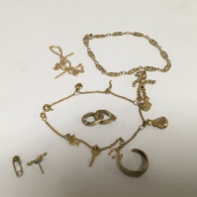 A 9carat gold charm bracelet one other gold bracelet a gold charm and other gold oddments. 10.5g