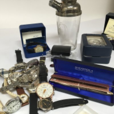 A collection of dress watches Sheaffer pen a cocktail shaker silver jewellery and other ornaments.