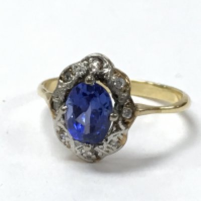An 18ct gold diamond and blue stone ring. 3.2g. Postage category a