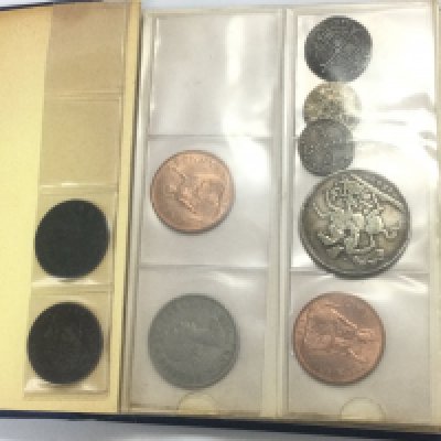 A blue coin book of circulated coinage. Shipping category A.