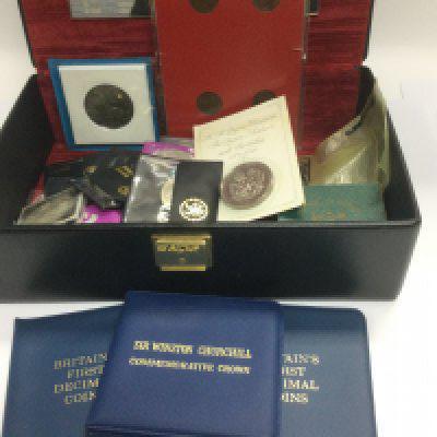 A box containing commemorative coins. Shipping category D.