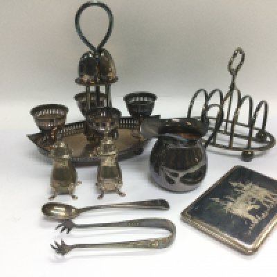 A collection of silver and silver plated items including a toast rack, cruets etc. Shipping category B.