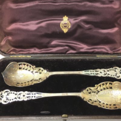 A cased pair of ornate silver hallmarked spoons. 23cm long. Postage category B