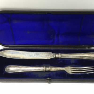 A cased silver hallmarked fish knife and fork. Postage category B