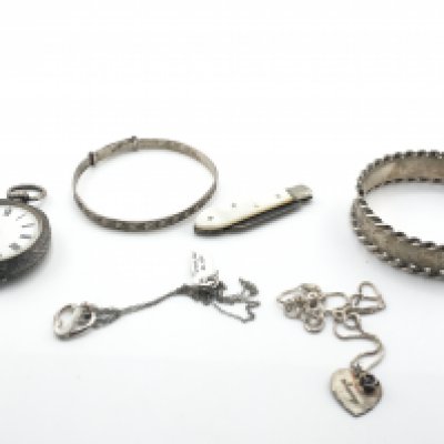 A silver bangle and silver chains along with other oddments. Postage B