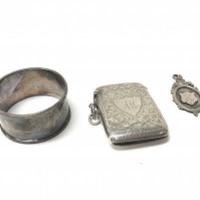 Silver hallmarked items including a Napkin ring, a medal and a silver plated vesta. Postage category a