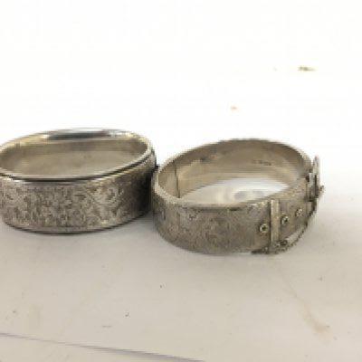 Two Silver bangles one with an ornate belt clasp. (2)