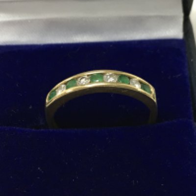 An 18ct gold emerald and diamond set half eternity ring. Size P/Q. Total weight 2.5g. Postage category a