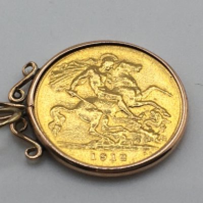A 1912 half Sovereign in a pendant mount. 4.70g Postage A