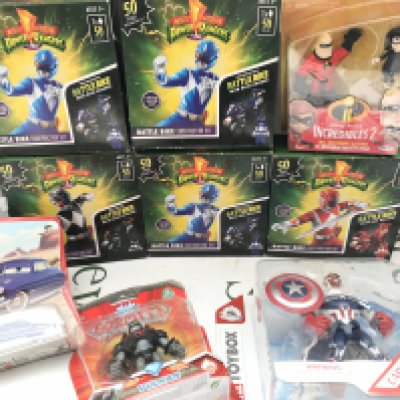 A Collection Of Boxed And a loose Toys. Including power Rangers. Masters Of The Universe. Power Rangers Sticker Books etc. No Reserve.