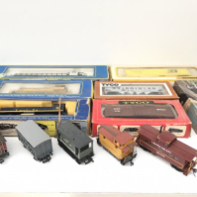 A collection 12 HO or OO gauge model railway accessories including 3x locomotives by AHM and 9 wagons by Bachmann..Tyco etc. mostly boxed. No reserve
