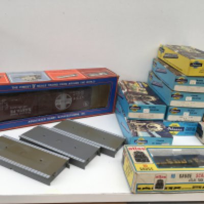 A collection of boxed HO gauge model railway items including 1x locomotive by Atlas and 9x assorted rolling stock by Athearn ..Bachmann and Walthers. Includes boxed O gauge Box Car by AHM and 3x platform sections. No reserve