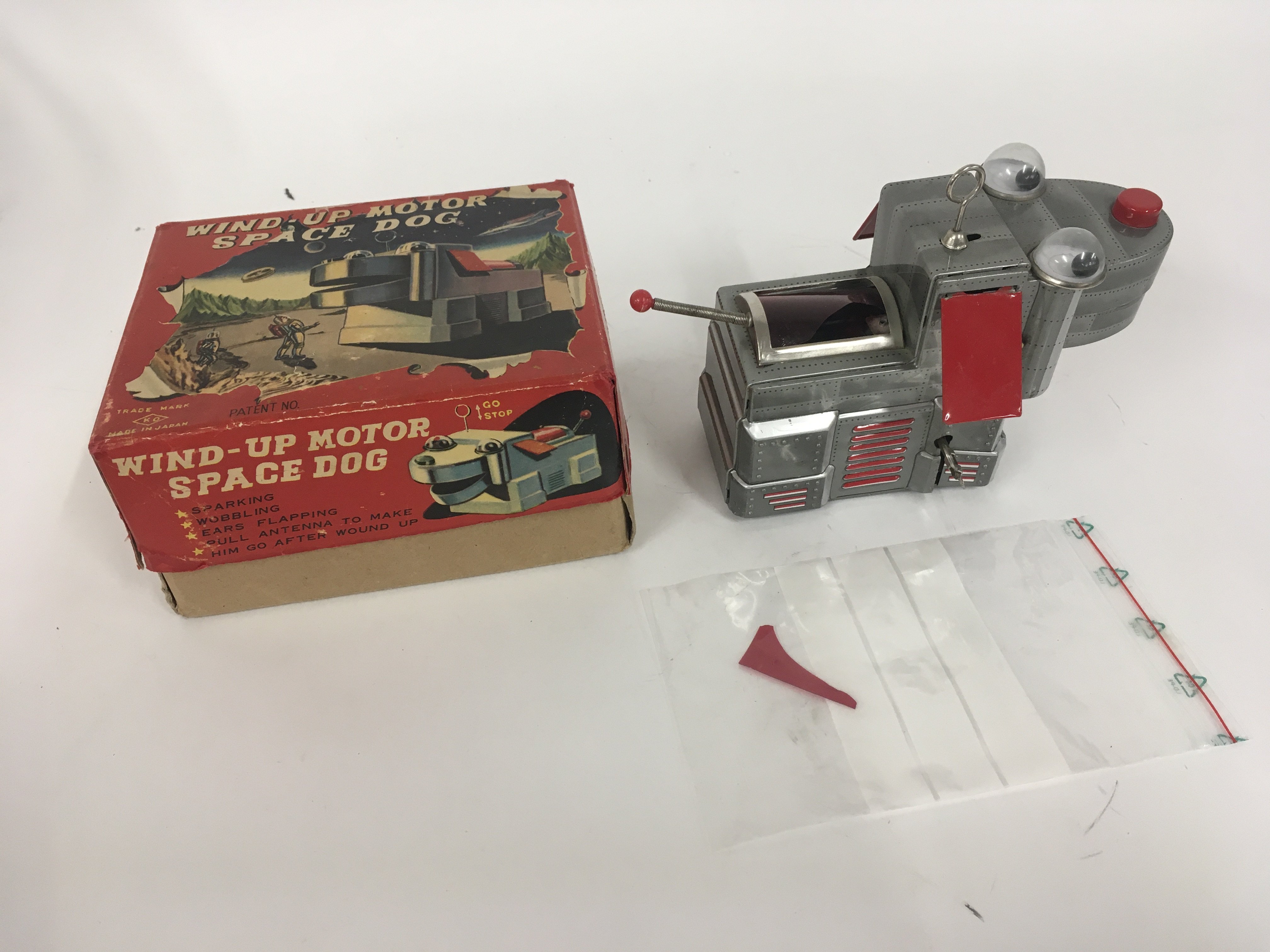 A boxed tin plate dog possibly 1957 made in Japan. Titled SPACE DOG it has several features. Has damage to rear sparking cover.