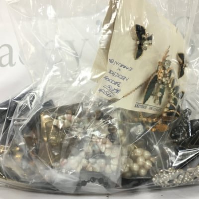 A collection of costume jewellery including necklaces, brooches. Postage category B