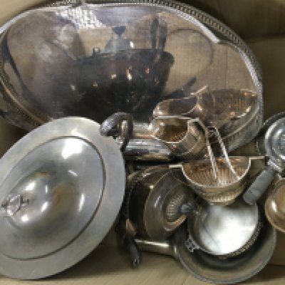 A box of silver plated dinner service items.