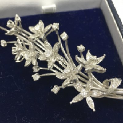 An 18ct white gold spray diamond brooch, total weight 16.2g postage category A