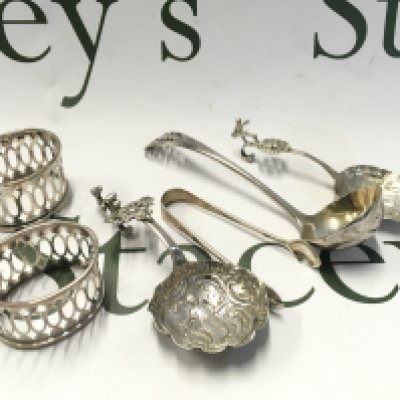 Two Continental silver tea caddy type spoons, a pair of napkin rings , tongs. NO RESERVE