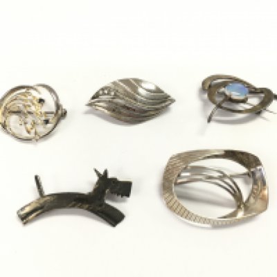 A collection of silver brooches. Postage B