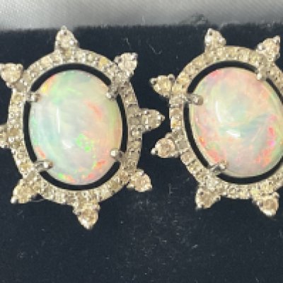 Pair of silver sunburst cluster stud earrings set with oval cabochon opals and diamonds with silicon back, boxed. Opals 4.50ct. Diamonds 0.82ct. Postage category A.