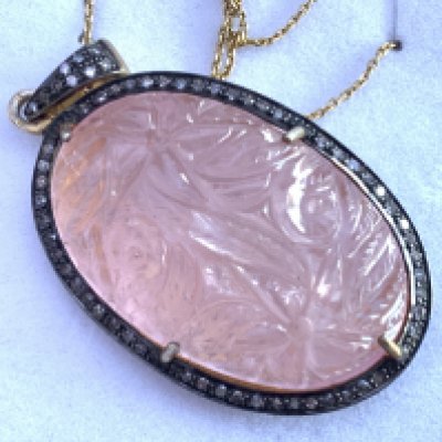 Large hand carved rose quartz pendant with diamond set halo and bale and diamond halo on gold plated silver chain, boxed. Postage category A.