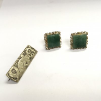 A 1924 badge and a pair of 1930s earrings.