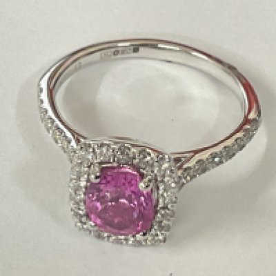 Platinum ring set with an oval pink sapphire with RBC diamonds set to the halo and shoulders. Sapphire 1.40ct. Diamonds 0.50ct. Postage category A.